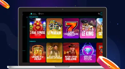 Laptop screen displaying a variety of popular slot games including 3 Rail Express and Legacy of Dead.