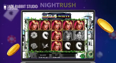 Black & White slot on a laptop with Jade Rabbit logo and two coins against a starry background.