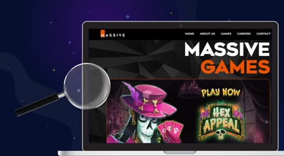Massive Studios site on a laptop with the brand logo and a magnifying glass against a dark setting.