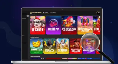 A laptop displays a casino lobby with slot games.