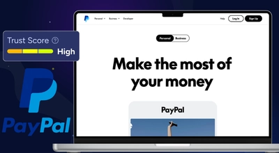 A laptop displaying the PayPal homepage with an overlay showing a high trust score.